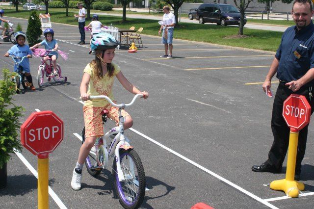 Young Girl Stops Bike at Course Stop Signs