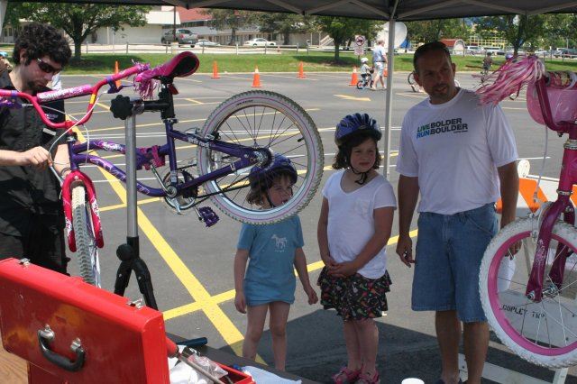 Young Girls Watch as Their Bike Gets Checked Over