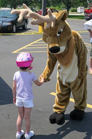 Young Rider Shakes Hand With Mascot Moose