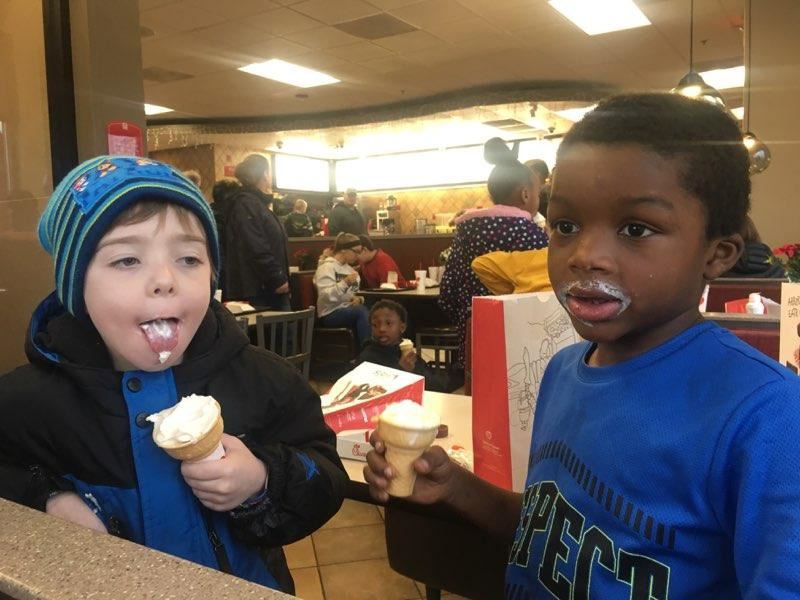 Two young boys eating ice cream