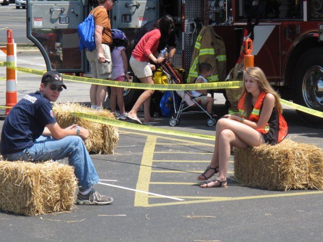 Volunteers Sit on Bales Waiting for Riders