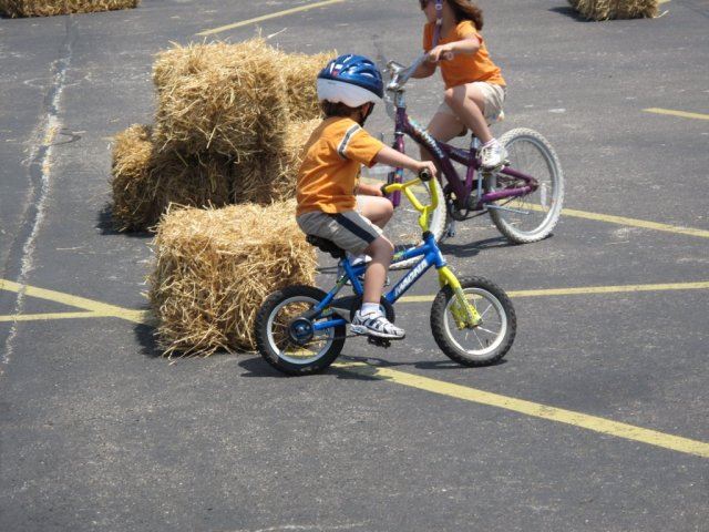 Young Child Rides Around Hay Bale