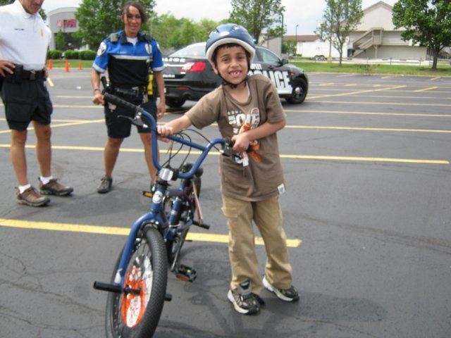 Young Boy Standing With His Bike