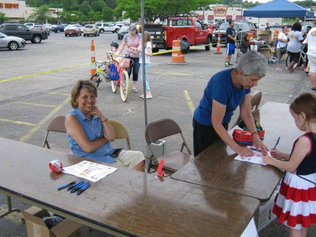 Volunteers Smile As they Give Out Tickets