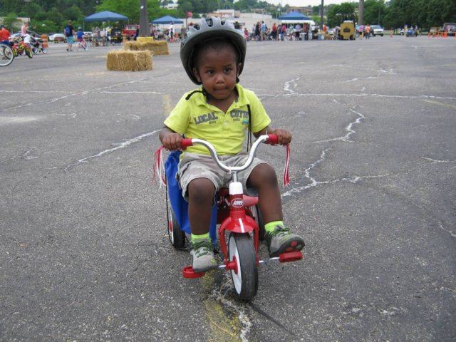 Young Child Focuses as he Rides His Bike