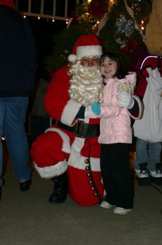 Santa Kneels With Young Girl