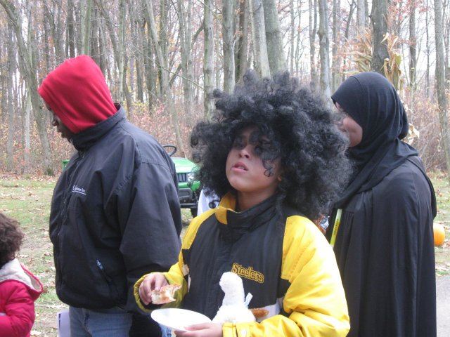Boy in Steelers Jacket and Wig Enjoys Snacks