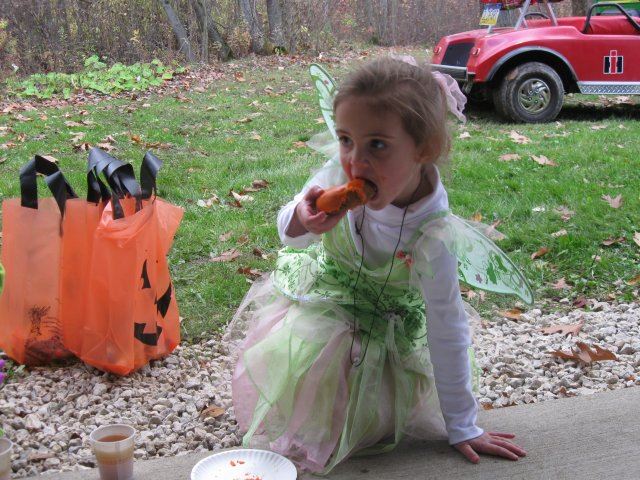 Young Child Enjoys a Donut In Costume