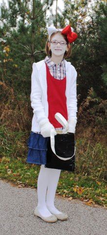 Young Girl with Red Bow Smiles With Bag