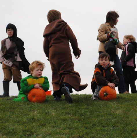 Young People in Costumes Holding Pumpkins