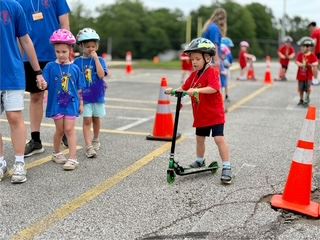 Safety Town Student Rides Scooter on Day 1 of Safety Town 2025