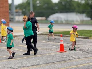 Safety Town Students Ride Scooter on Day 1 of Safety Town 2025
