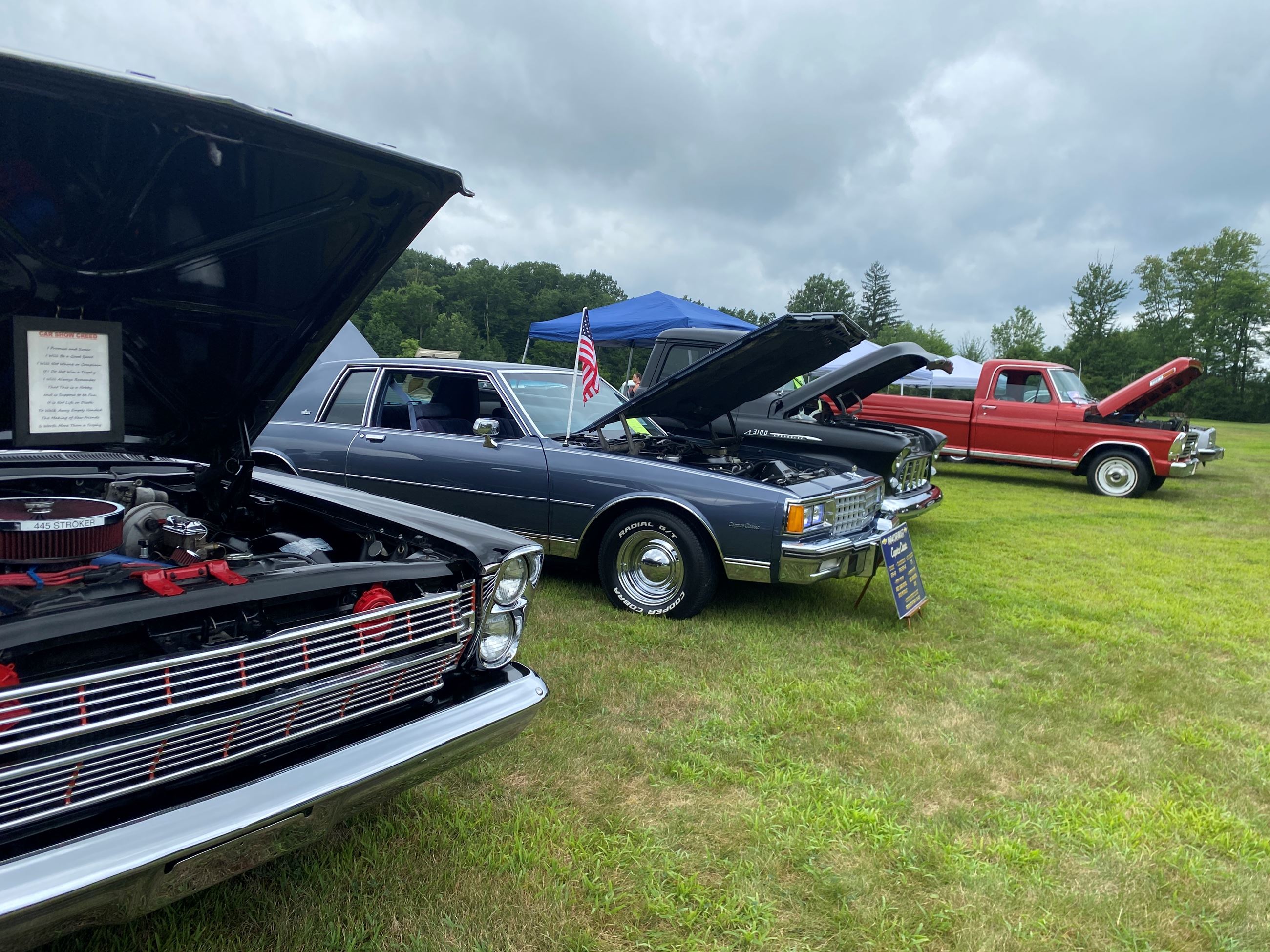 Rows of Vintage Cars With Their Hood On Display at Car Show 2025