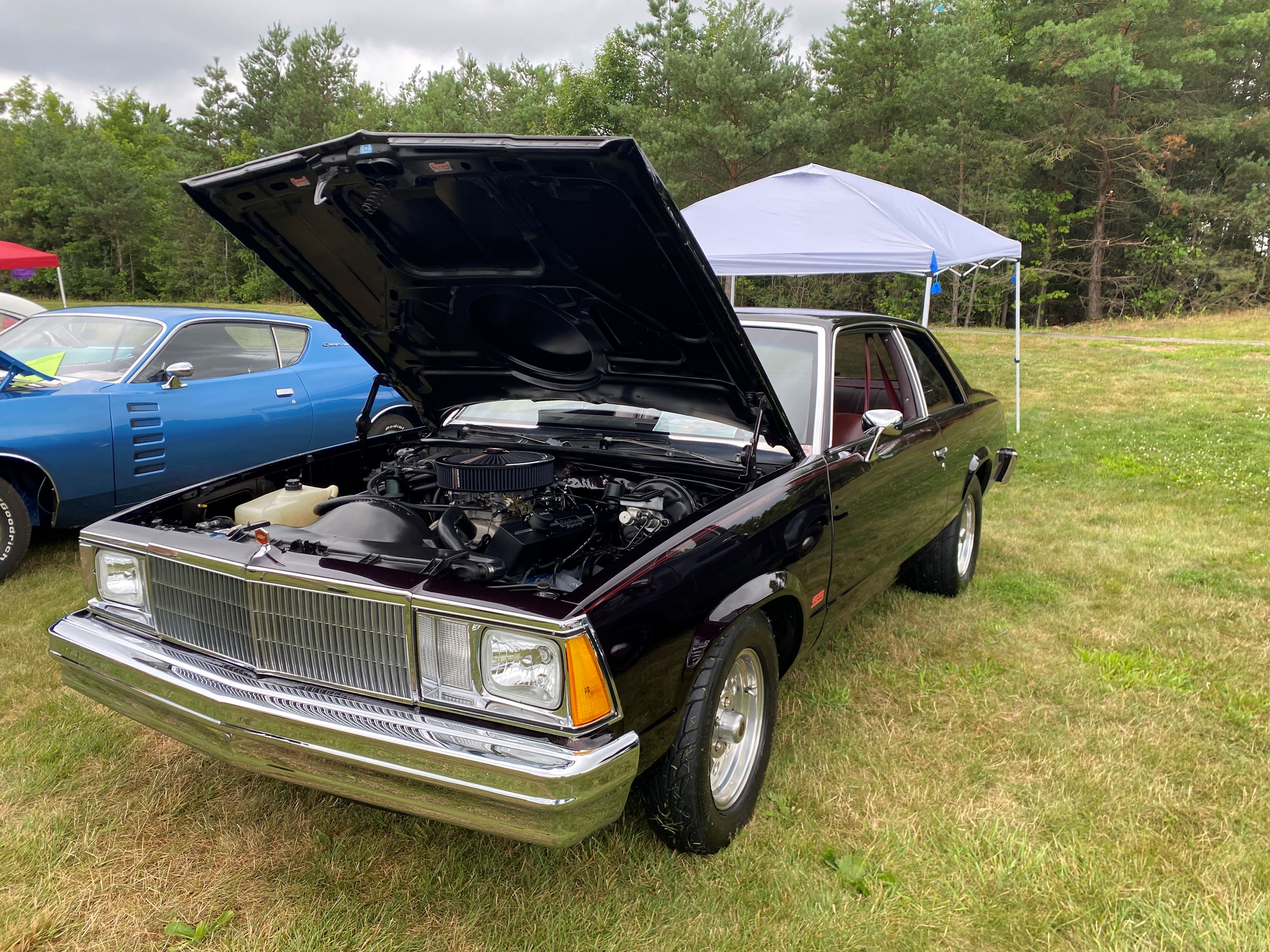 Vintage Black Car With It's Hood Up at Car Show 2025