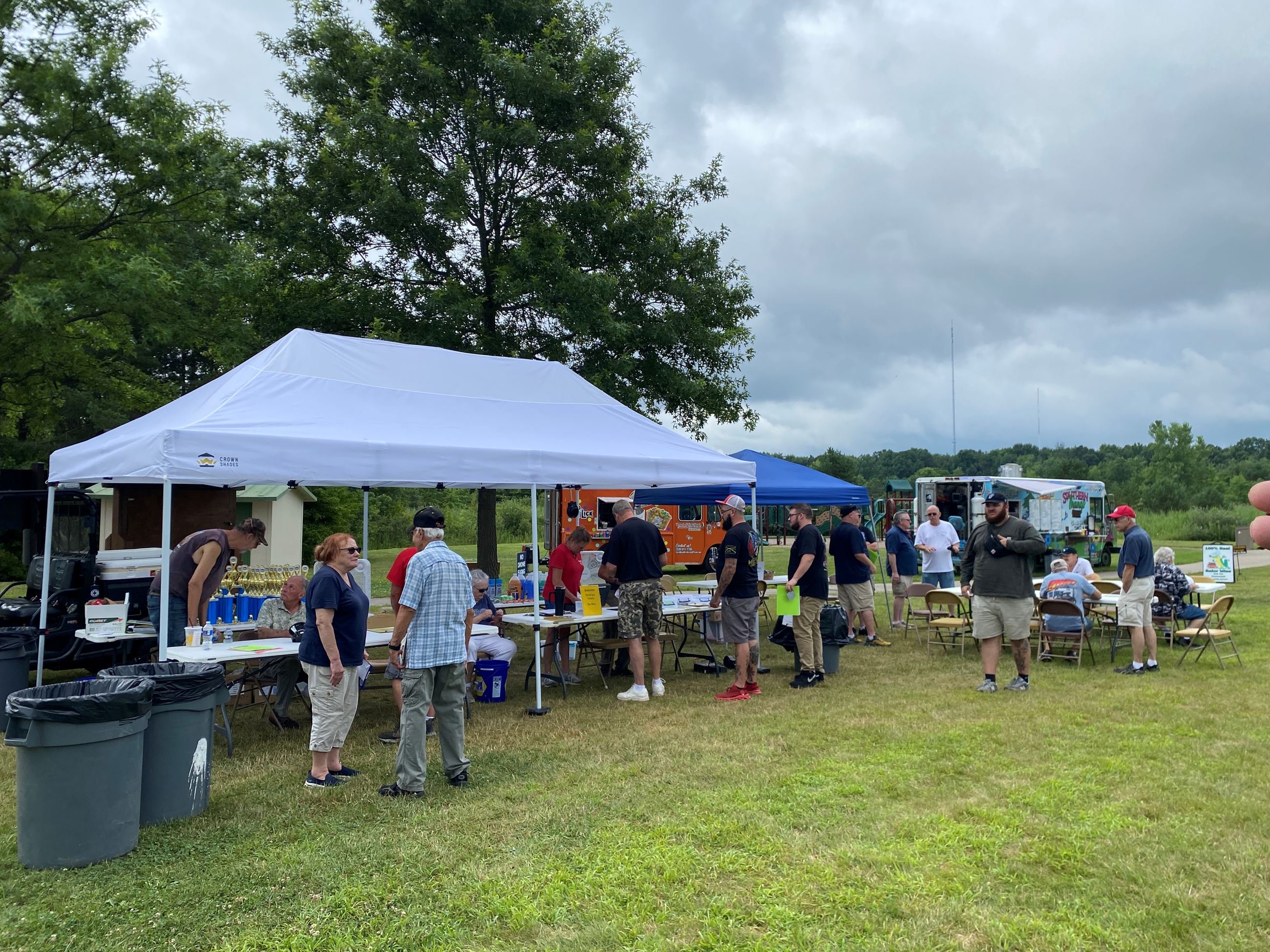 White Tents Are Shown with people sitting underneath them