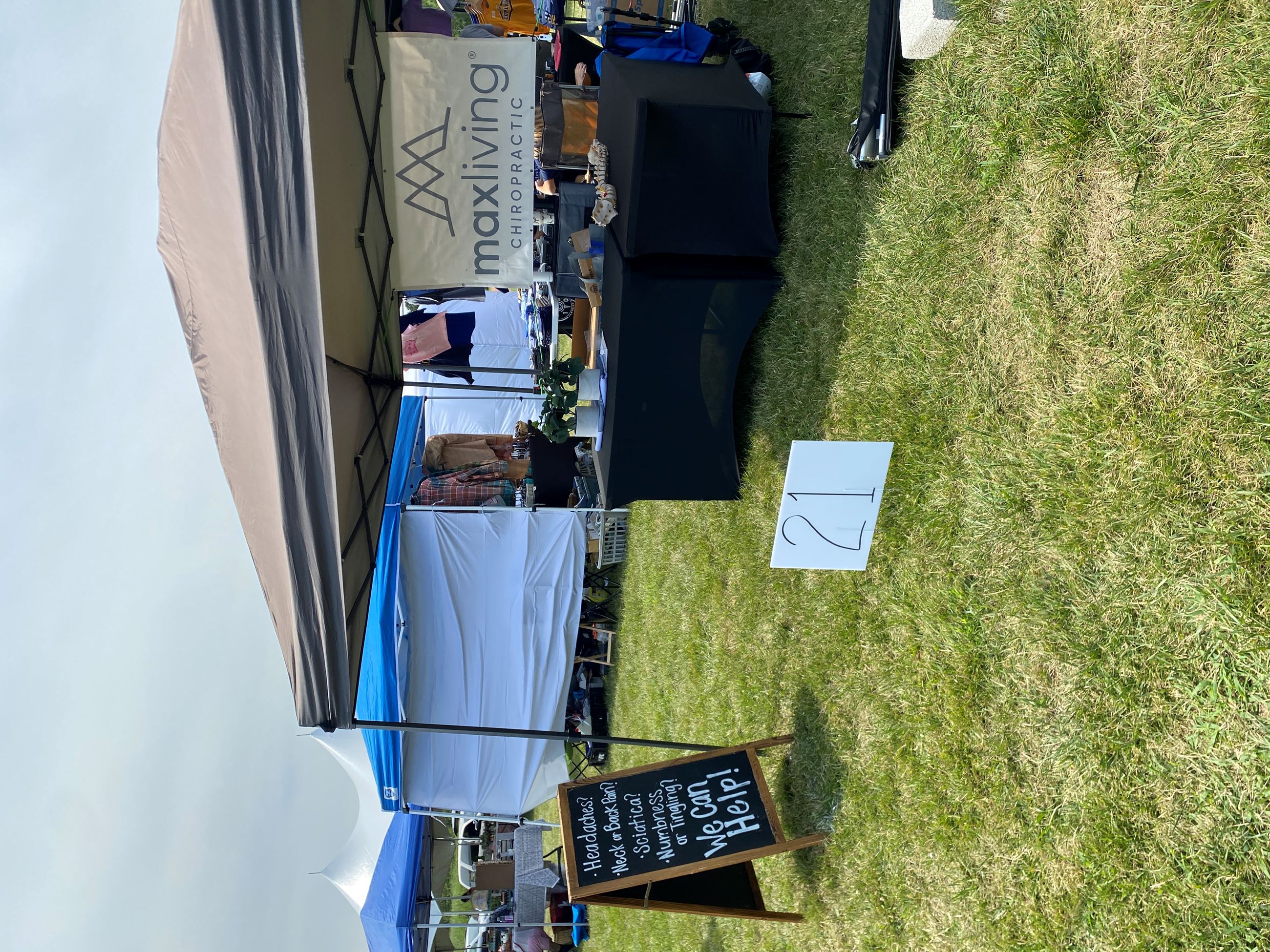 Vendors Set Up Under a Tan Tent At Copley Community Park on Saturday For Heritage Days 2025