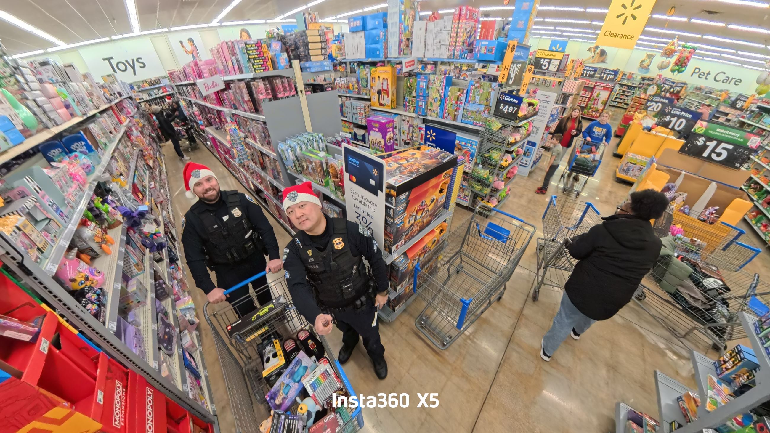 2 Officers take a picture from a high angle in a shopping aisle