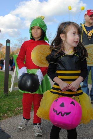 Young Children Wear Costumes and Hold Candy
