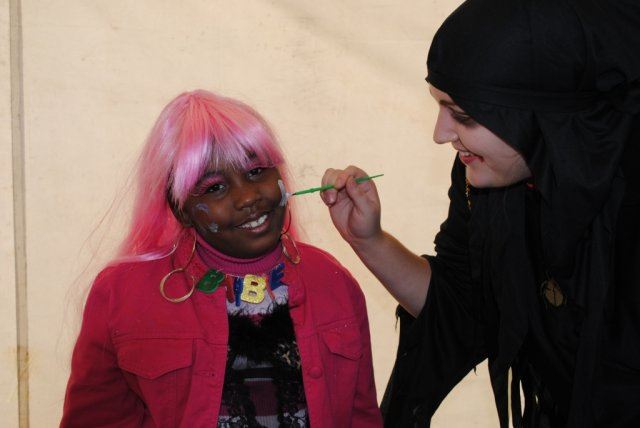 Young Girl Smiles While Getting Face Painted